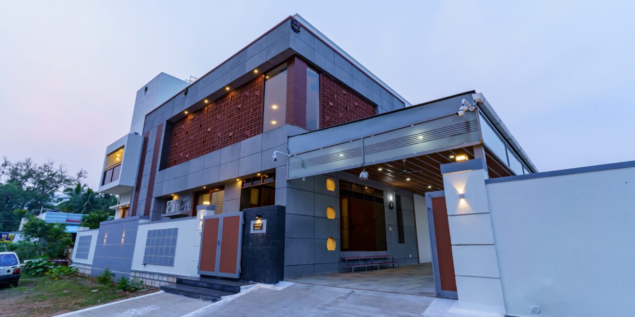 Modern facade of a 3BHK house in Salem featuring exposed concrete panels.